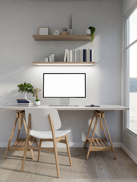 istock White screen computer with books and a wooden figure aside on white table in a clean bright room. 2238226262