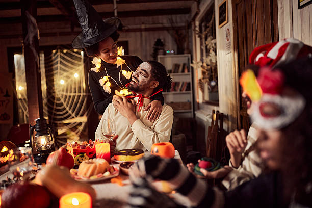 istock Happy black parents talking during Halloween in dining room. 2238231946