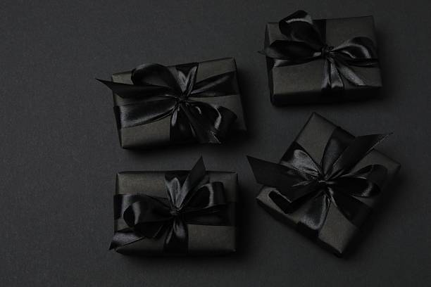 istock black gift boxes with black ribbons on a black background 2238232000