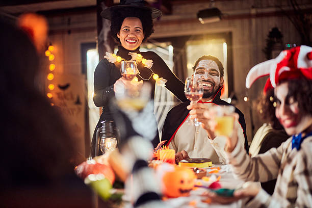 istock Happy black parents enjoying during Halloween in dining room. 2238232057