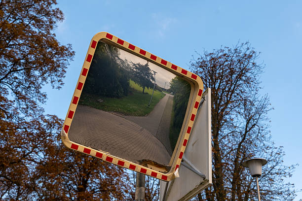 istock Reflective mirror captures serene pathway among autumn trees in the evening light 2238232372