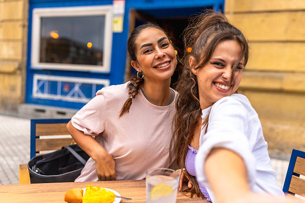 istock Two young women taking a selfie while having lunch at a restaurant 2238233299