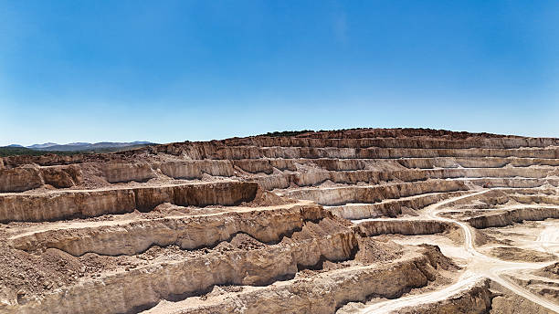 Quarry site with step terraces and visible geological strata.