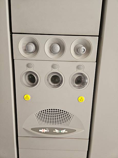 istock An overhead panel on an airplane with individual air vents, reading lights, and a speaker system. 2238233904
