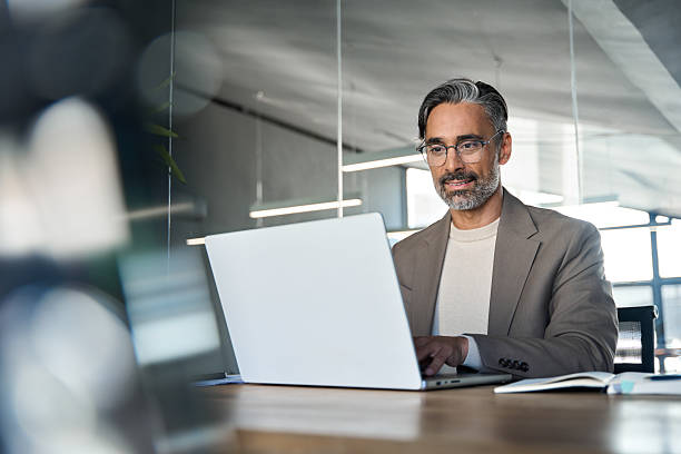 istock Busy middle aged business man executive ceo sitting at desk using laptop. 2238235760