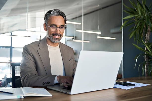 istock Busy middle aged business man executive ceo sitting at desk using laptop. 2238235769