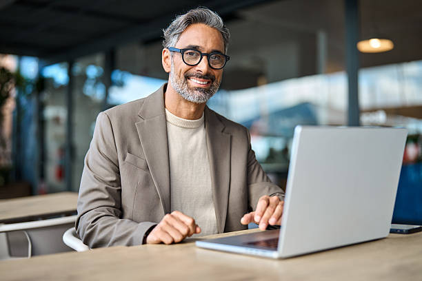 istock Happy mature business man executive sitting at outdoor table using laptop. 2238235802