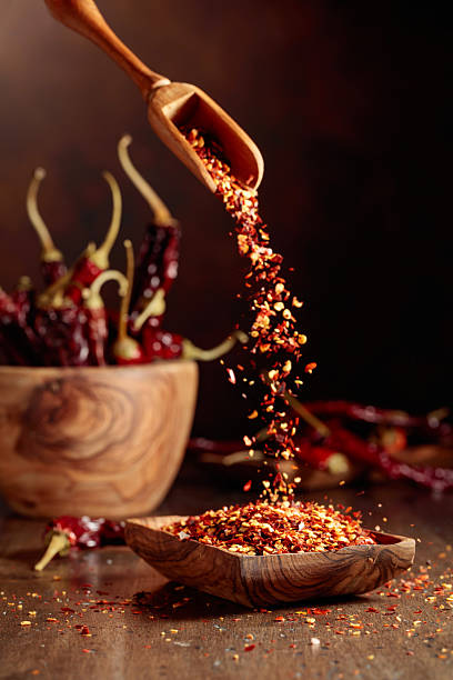 istock Chilli flakes are poured into a wooden dish. 2238240337