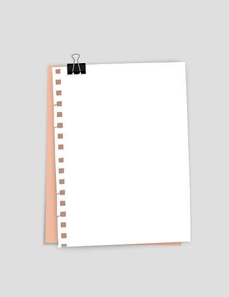 istock Ruled sheet of paper fastened with a paper clip on a gray background 2238242833