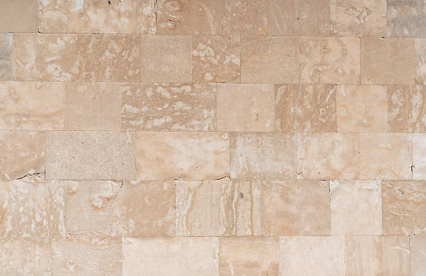 istock Antique ancient stone wall masonry texture background. Old wall made of beige stone blocks 2238244204
