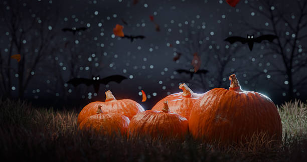istock Halloween night scene with glowing pumpkins on grass 2238247886