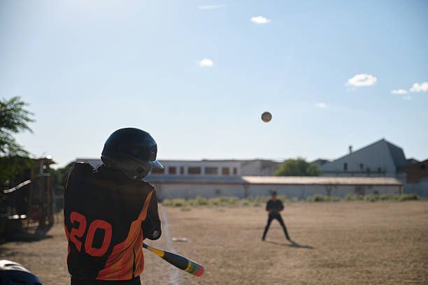 istock Young baseball player hitting ball during daytime game 2238249273