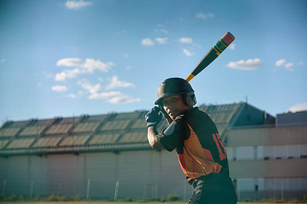 Young female cricket player putting her helmet on