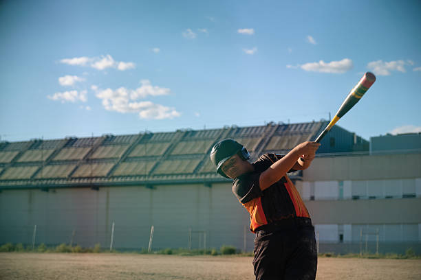 istock Boy batter swinging baseball bat in action 2238250471