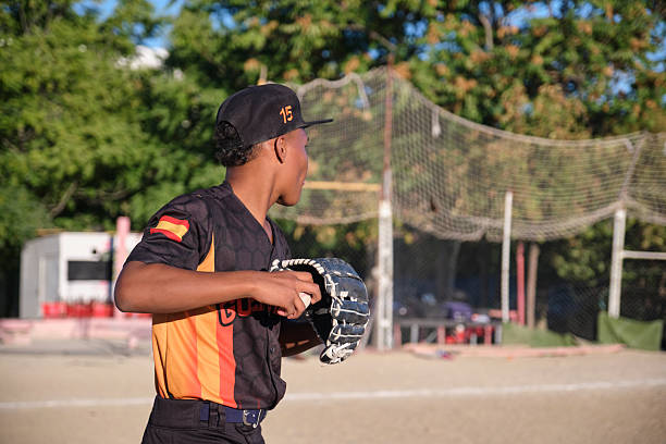Baseball players practicing pitching on the baseball field.