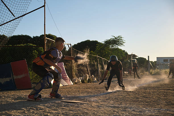 Young baseball players competing on a dusty field during a game