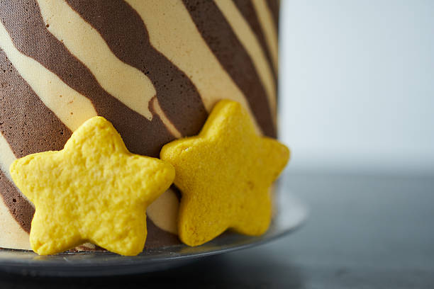Festive cake on a gray background. Chocolate cake and star-shaped cookies on a gray background.