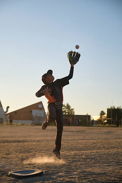 istock Boy player jumping catching baseball in action on field 2238254991