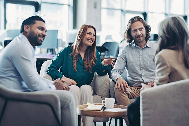 istock Mixed group of entrepreneurs sitting around a table and talking 2238255684