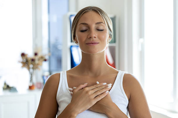 istock Blonde woman smiling with hands on chest 2238255972