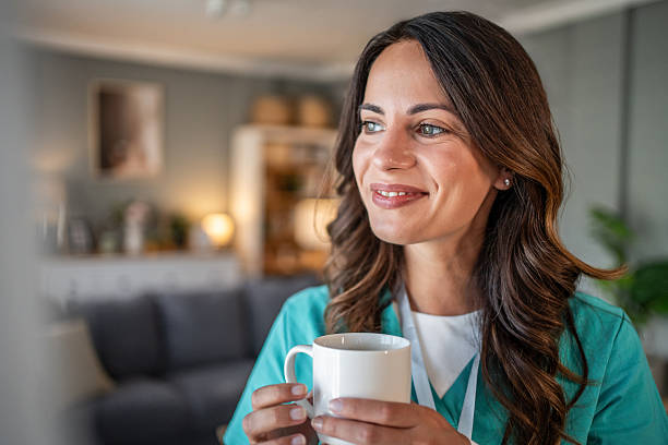 istock Happy nurse enjoying coffee break at home 2238257978