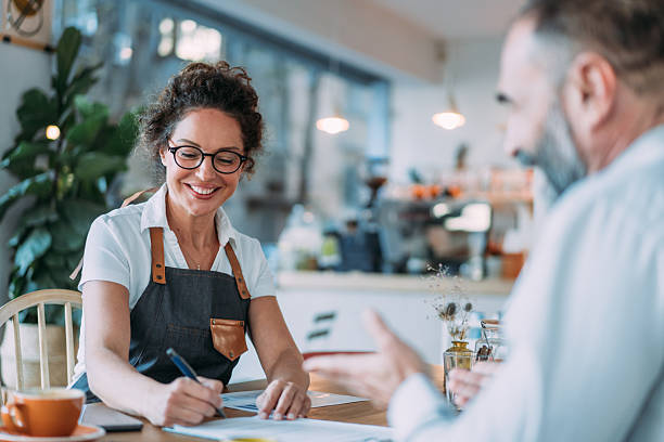 Coffee shop owner meeting with financial advisor.