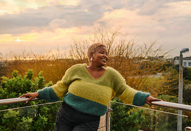 istock Joyful African Woman Enjoying Sunset Outdoors Relaxing on Balcony with Greenery 2238259824