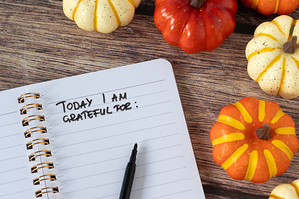 istock Today I am grateful for, handwritten text in notebook with pumpkins on wooden background 2238260156