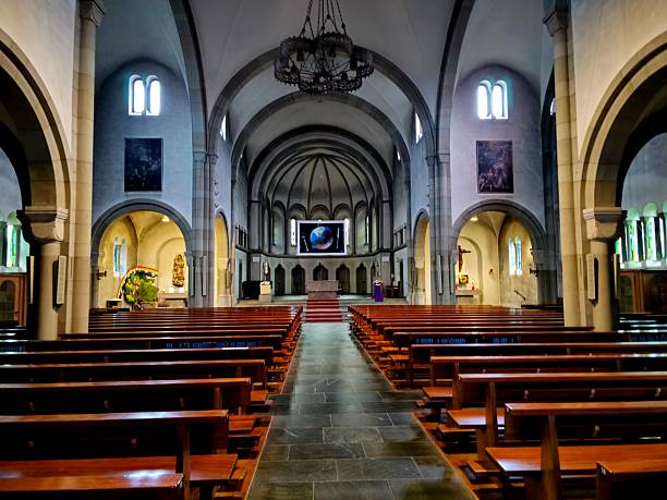 The parish church of St. Philipp Neri von Reussbühl was built between 1898 and 1902 according to the plans of the Lucerne architect Wilhelm Hanauer. The image shows the church on a cloudy day in spring season.