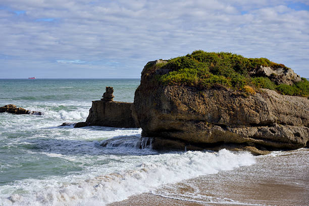 istock Large coastal rock formation with ocean waves 2238266527