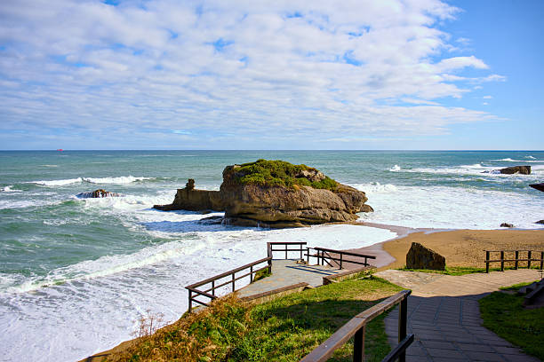 Seaside walkway leading to ocean waves and cliffs
