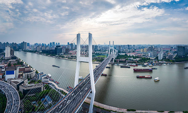 istock Aerial view of a modern cable stayed bridge with dense traffic crossing a wide river in Shanghai. 2238269098