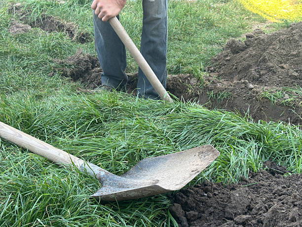 istock A worker digs a trench with a shovel to lay a pipe 2238271519