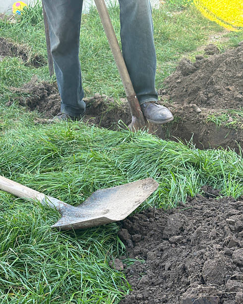 istock A worker digs a trench with a shovel to lay a pipe 2238271533