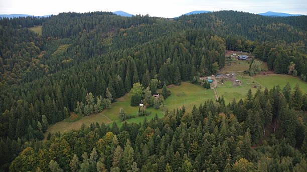 istock Autumn in the mountains with dramatic clouds, captured from a drone. A panoramic view of colorful autumn forests, rolling hills, and distant Czech mountain peaks. 2238272459
