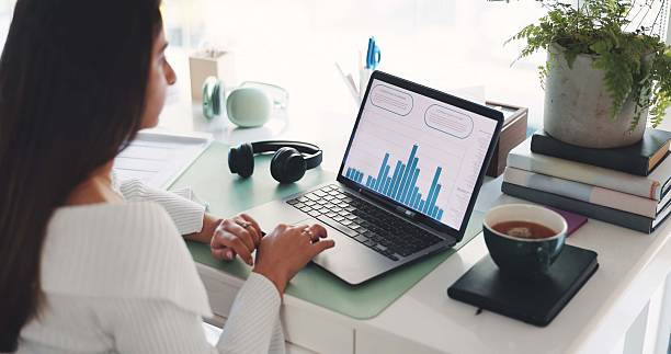 istock Business woman, laptop and statistics with chart for performance review or analytics in office. Female person, analyst or accountant with computer, graph or data for revenue, growth or development 2238274663
