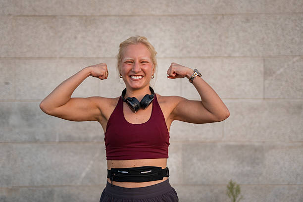 istock Young woman flexing biceps after outdoor workout 2238276713