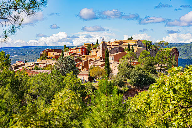 Red cliffs at Roussillon in the Provence during a summer day in France. Roussillon is famous for the red Ochre soil.