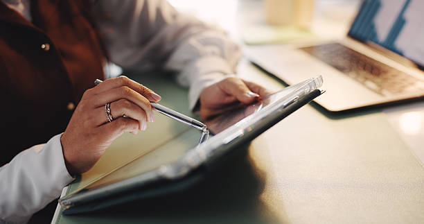 istock Hand, research and writing on tablet in office, finance data or online trends for strategy planning. Statistics info, analyst and business woman with digital app, review or report for company growth. 2238280068