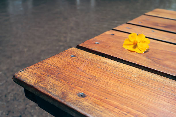 istock Wooden table with a yellow paperclip, workspace setting, minimalistic design, suitable for notes or reminders. 2238282085