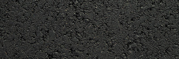 istock New dark black asphalt background. Closeup. Wide banner. Empty place for text. Top down view. 2238282917