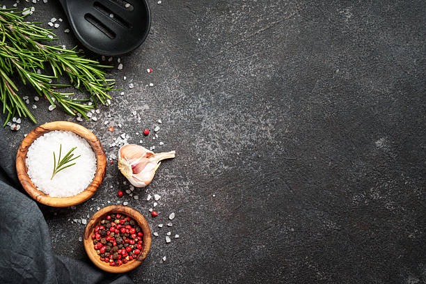 istock Kitchen table, Food background with ingredients. Spices and herbs at black top view. 2238284765