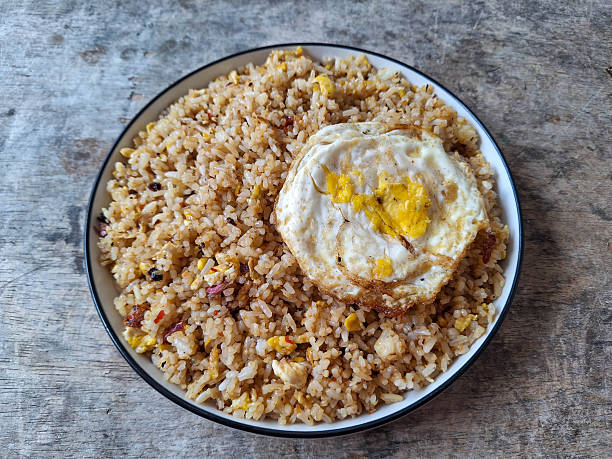 Nasi Goreng Telur or Fried Rice with Omelette Egg on a plate. Food Menu.