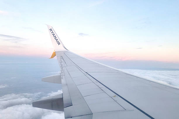 Paris, France, July 26, 2025: Airplane wing in flight above the clouds during a serene sunset. the soft pastel hues in the sky enhance the sense of tranquility and wanderlust, capturing the essence of travel and adventure.