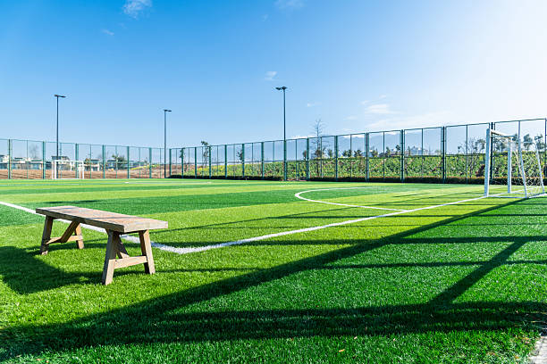 istock Empty bench in football field 2238290559