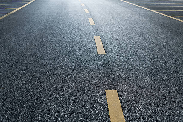 istock A parking space with yellow dividing lines on an empty asphalt road 2238290574