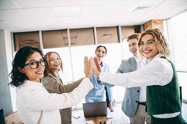 istock Cheerful office team achieving success together with a high five gesture in a modern professional workspace environment 2238291897
