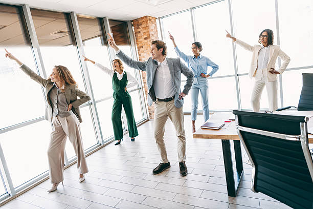 istock Diverse group of professionals engaging in lively team activity in a modern office space to foster teamwork and collaboration 2238292103