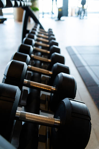 Rows of different dumbbell weights at a gym
