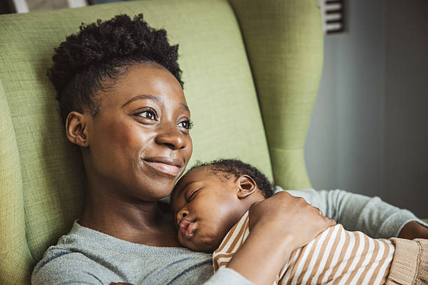 istock Mother holding sleeping baby 2238292210